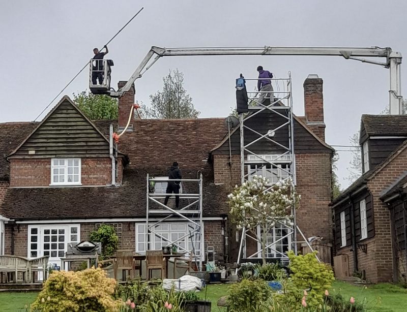 The Moss Cleaners using cherry picker and scaffolding to clean roof safely and professionally in Kenilworth, Warwickshire